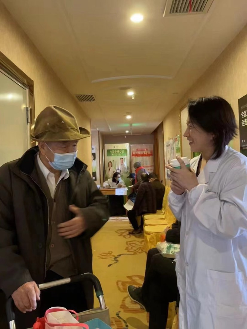 An elderly resident talks with a physician during a free clinic day at a community health centre
